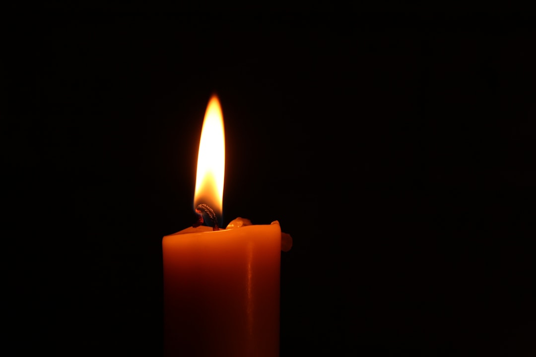 A memorial candle glowing in soft light